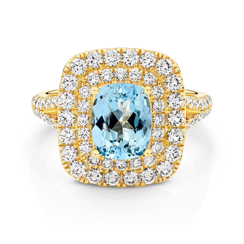 18ct yellow gold ring featuring a 1.82ct cushion cut Aquamarine with a double halo of RBC white diamonds.